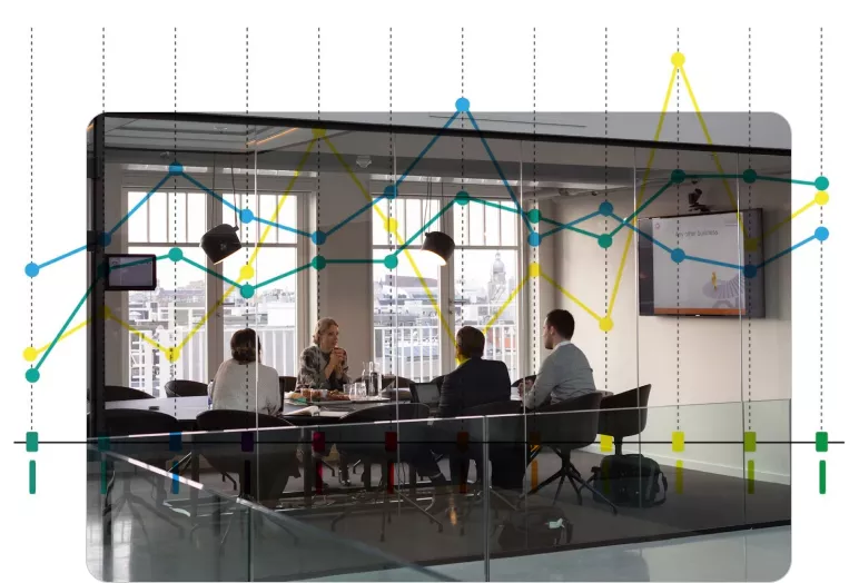 Business optimization: Professionals in a meeting with data graphs overlaying strategy discussions